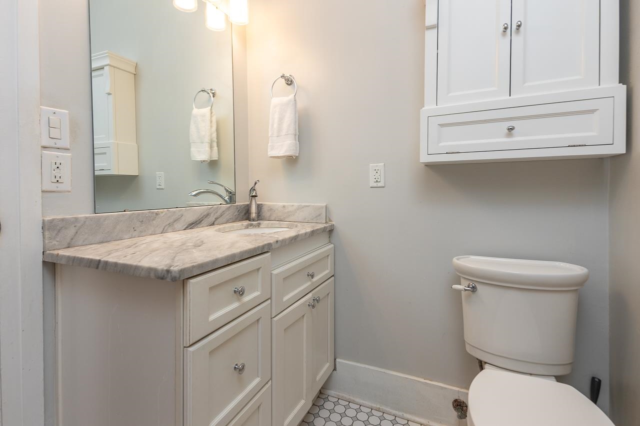 519 Summitt Street Memphis, TN 38104 - Photo 30 of 40 a bathroom with a granite countertop toilet sink and mirror