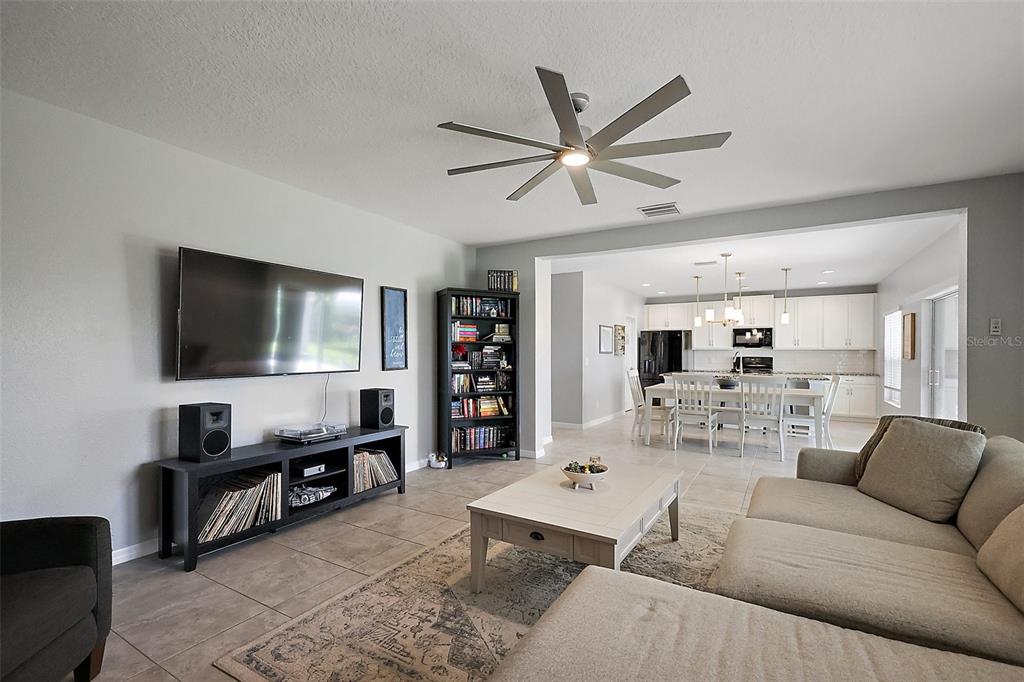 1292 Cavender Creek Road Minneola, FL 34715 - Photo 15 of 36 a living room with furniture and a flat screen tv