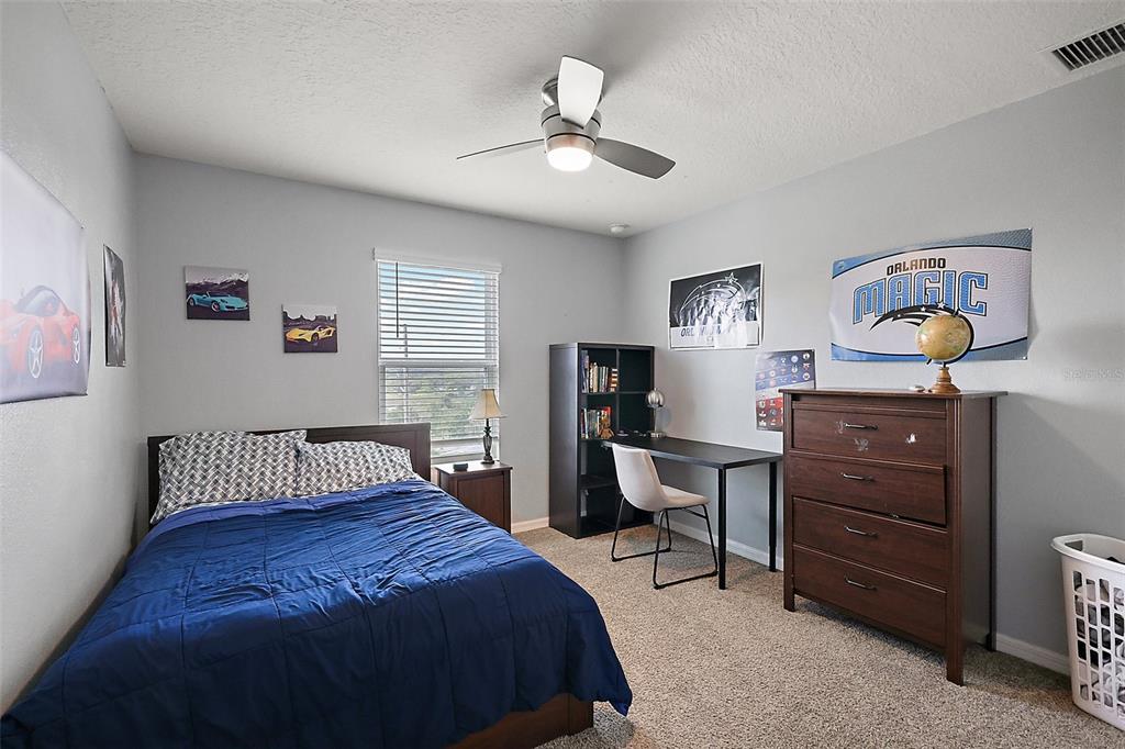 1292 Cavender Creek Road Minneola, FL 34715 - Photo 21 of 36 a bedroom with a bed and wooden floor