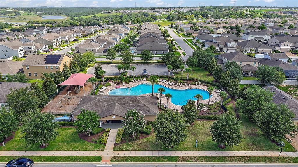 1292 Cavender Creek Road Minneola, FL 34715 - Photo 35 of 36 an aerial view of residential houses with outdoor space and parking