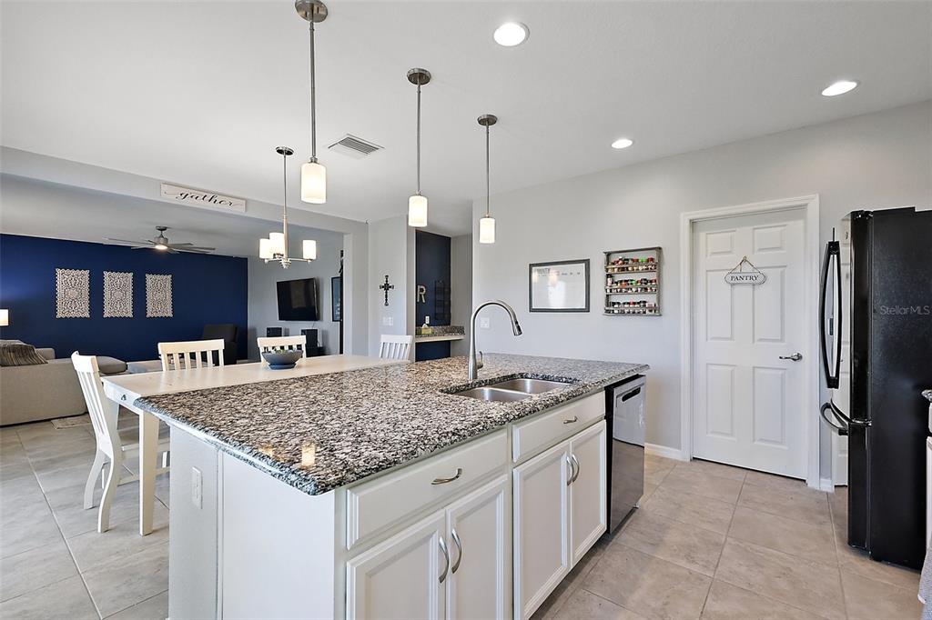 1292 Cavender Creek Road Minneola, FL 34715 - Photo 9 of 36 a kitchen with stainless steel appliances granite countertop stove top oven and refrigerator