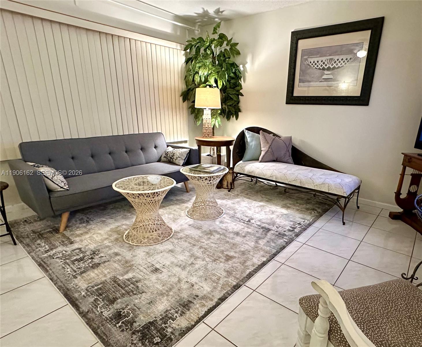 a living room with furniture and a potted plant