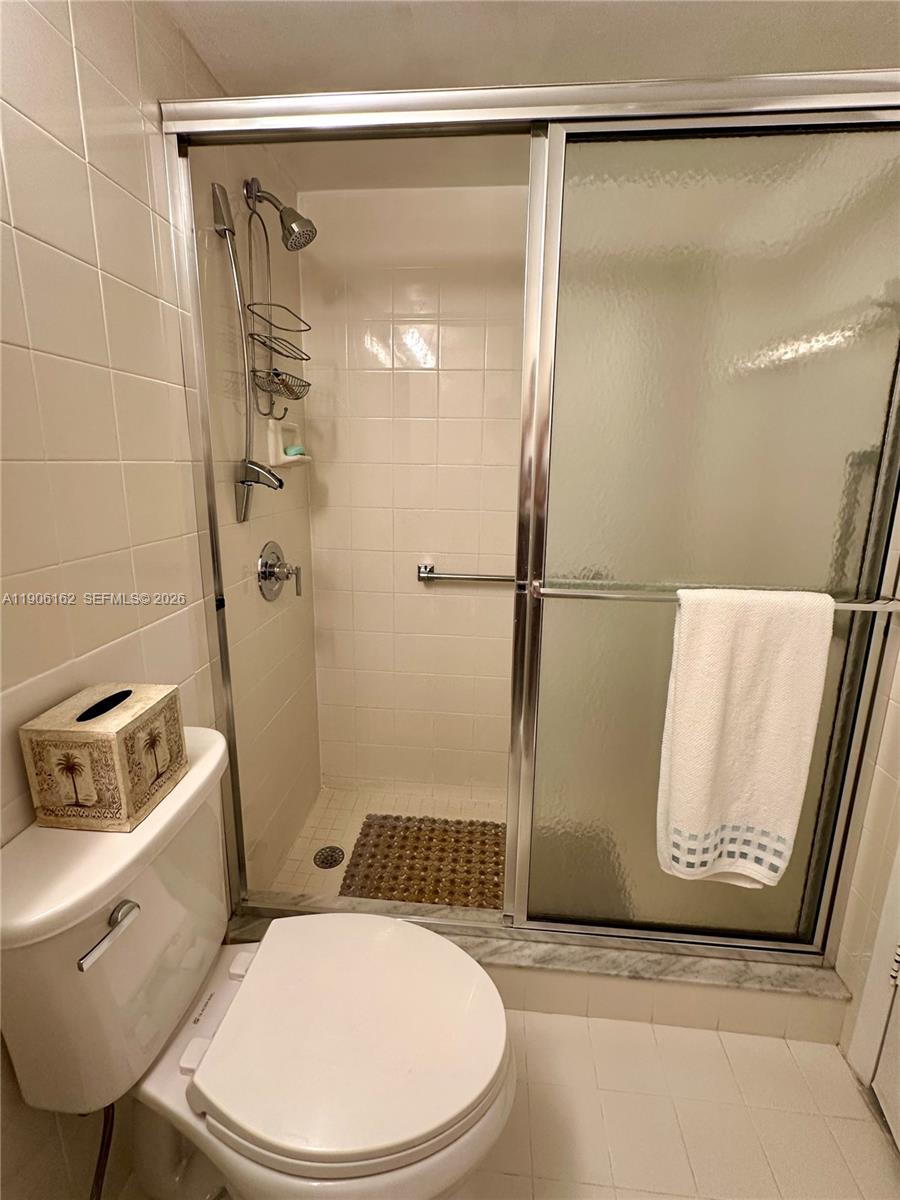 142 Preston F, Unit 142 Boca Raton, FL 33434 - Photo 12 of 28 a bathroom with a toilet and a shower