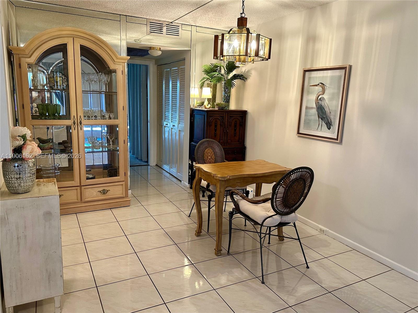 142 Preston F, Unit 142 Boca Raton, FL 33434 - Photo 2 of 28 a view of a dining room with furniture and chandelier