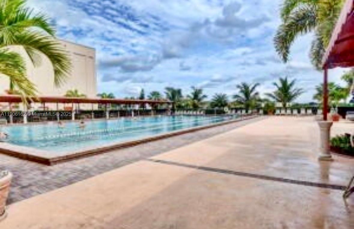 142 Preston F, Unit 142 Boca Raton, FL 33434 - Photo 21 of 23 a view of a swimming pool with a yard