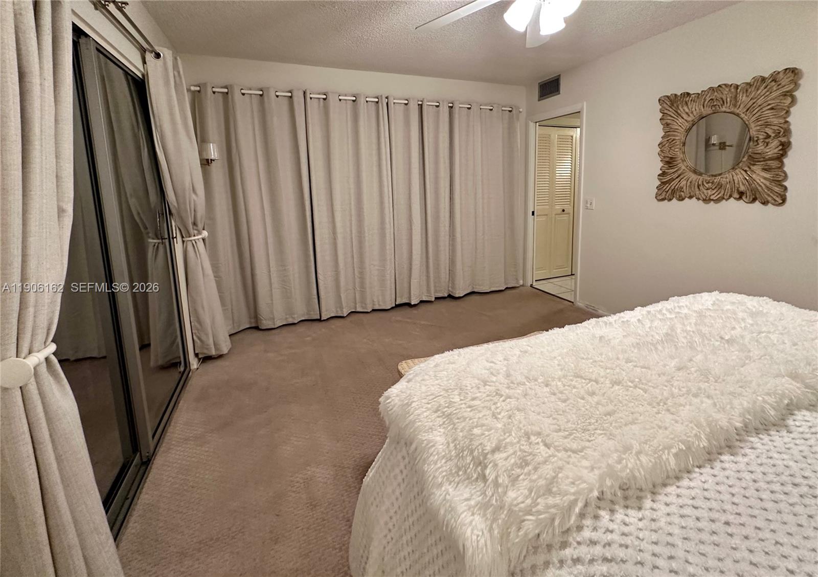 142 Preston F, Unit 142 Boca Raton, FL 33434 - Photo 9 of 28 a large white bed in a white room