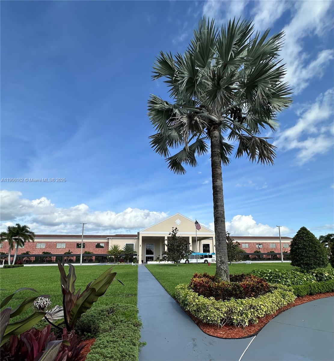 142 Preston F, Unit 142 Boca Raton, FL 33434 - Photo 10 of 23 a front view of a house with a yard and potted plants