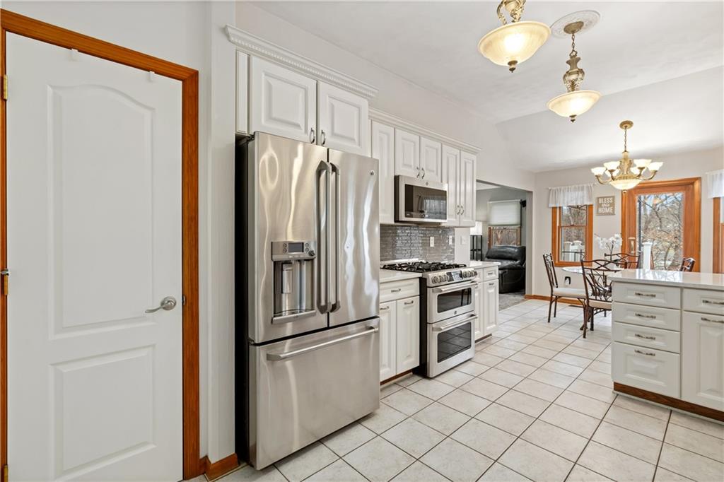 2108 Mickanin Road Irwin, PA 15642 - Photo 10 of 31 a kitchen with white cabinets and stainless steel appliances