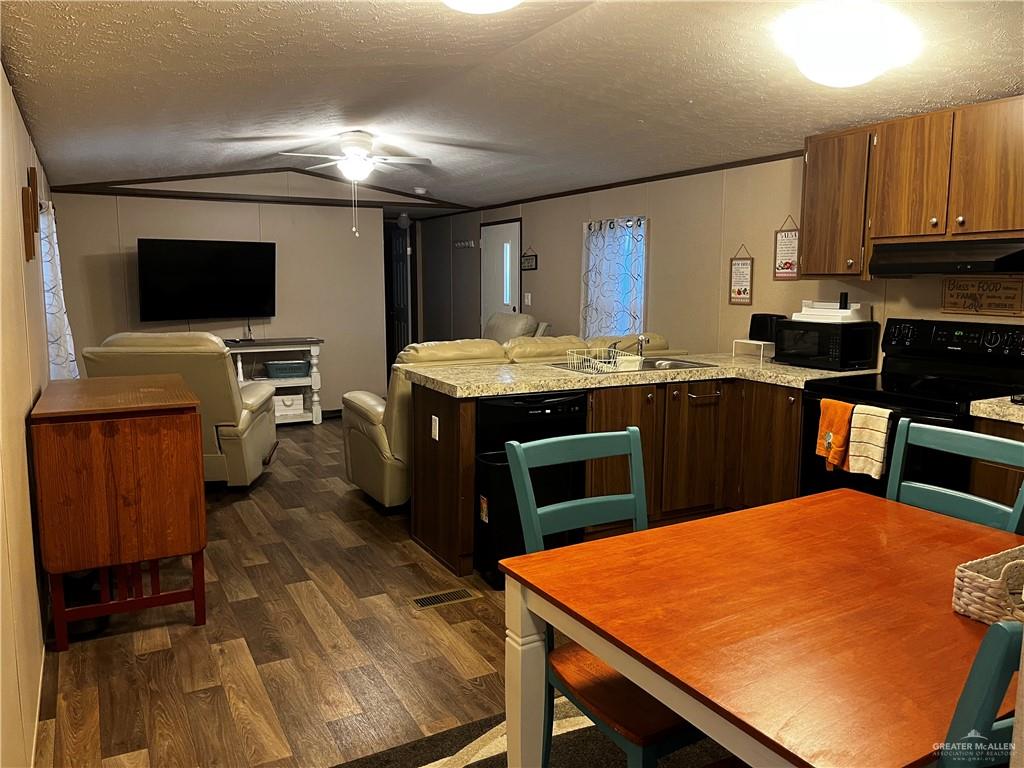 2503 Double Eagle Drive Mission, TX 78572 - Photo 7 of 15 a kitchen with kitchen island a sink appliances and cabinets