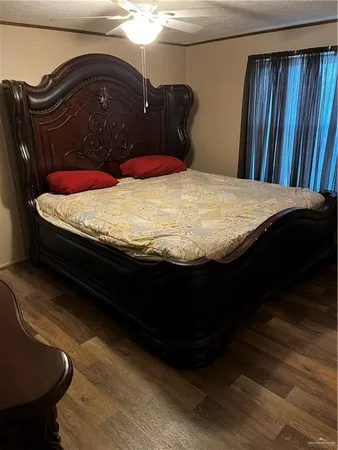 a bed sitting in a bedroom next to a window