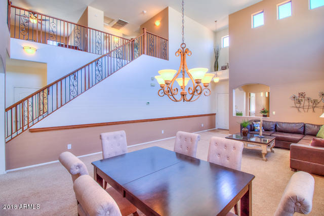 42811 West Venture Road Maricopa, AZ 85138 - Photo 18 of 61 a living room with furniture kitchen view and a chandelier
