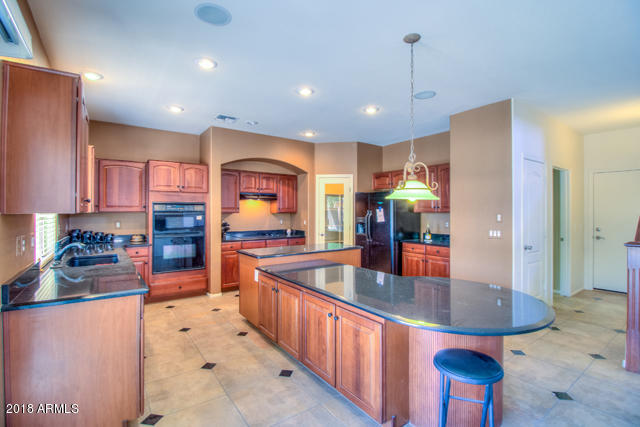 42811 West Venture Road Maricopa, AZ 85138 - Photo 27 of 61 a kitchen with stainless steel appliances granite countertop a sink and refrigerator