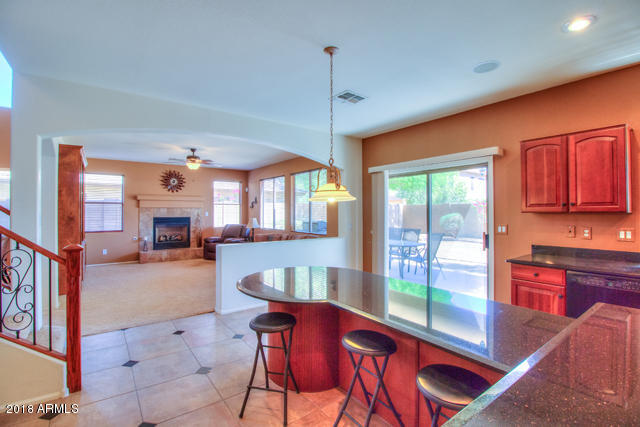 42811 West Venture Road Maricopa, AZ 85138 - Photo 34 of 61 a dining room with furniture a chandelier and wooden floor