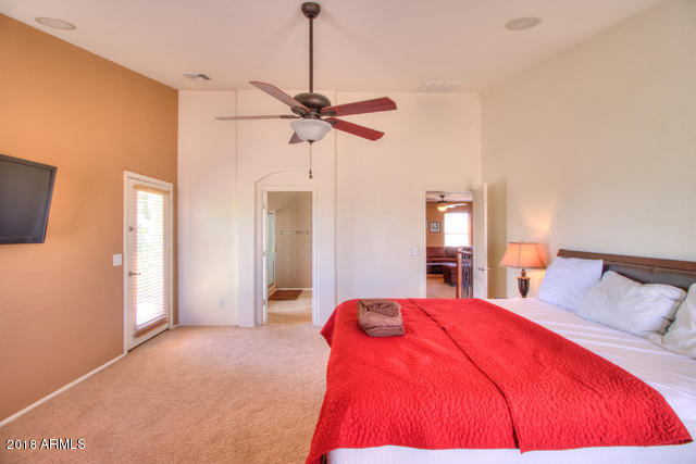 42811 West Venture Road Maricopa, AZ 85138 - Photo 46 of 61 a bedroom with a bed and a chandelier