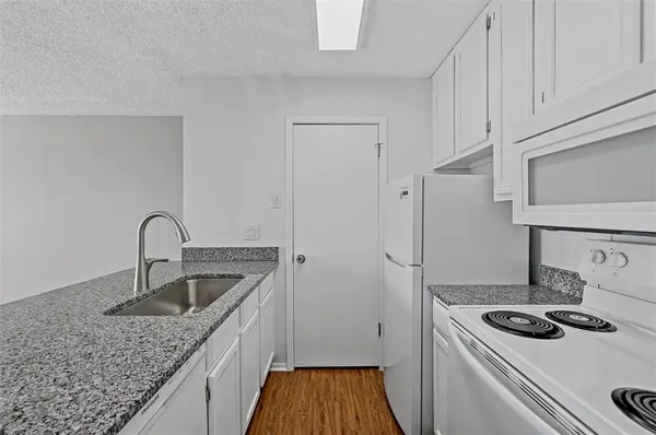 a kitchen that has a sink and a stove
