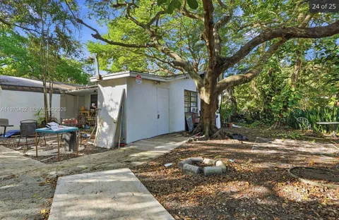 a backyard of a house with table and chairs