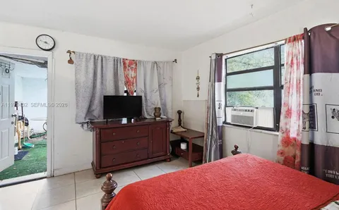 a bed room with a bed and a television