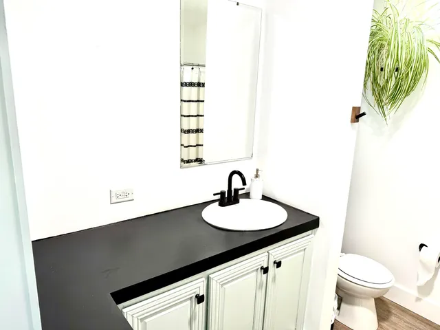 a picture of a bathroom with a sink and a mirror