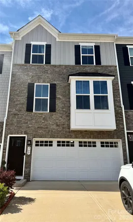 a front view of a house with garage