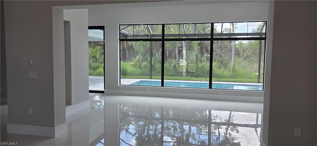 563 15th Street Northwest Naples, FL 34120 - Photo 14 of 22 a view of a glass door with a yard from a window