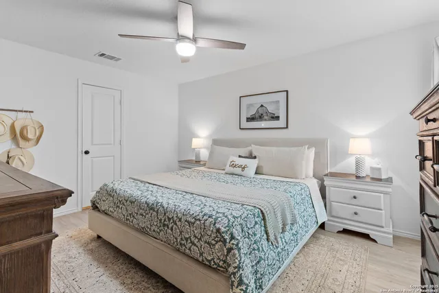 a bathroom with a granite countertop sink mirror vanity and toilet