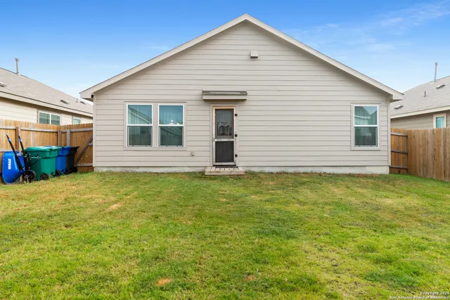 a view of a house with a yard and sitting area