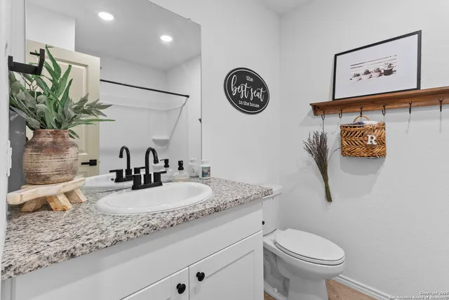 a bedroom with a bed and a potted plant