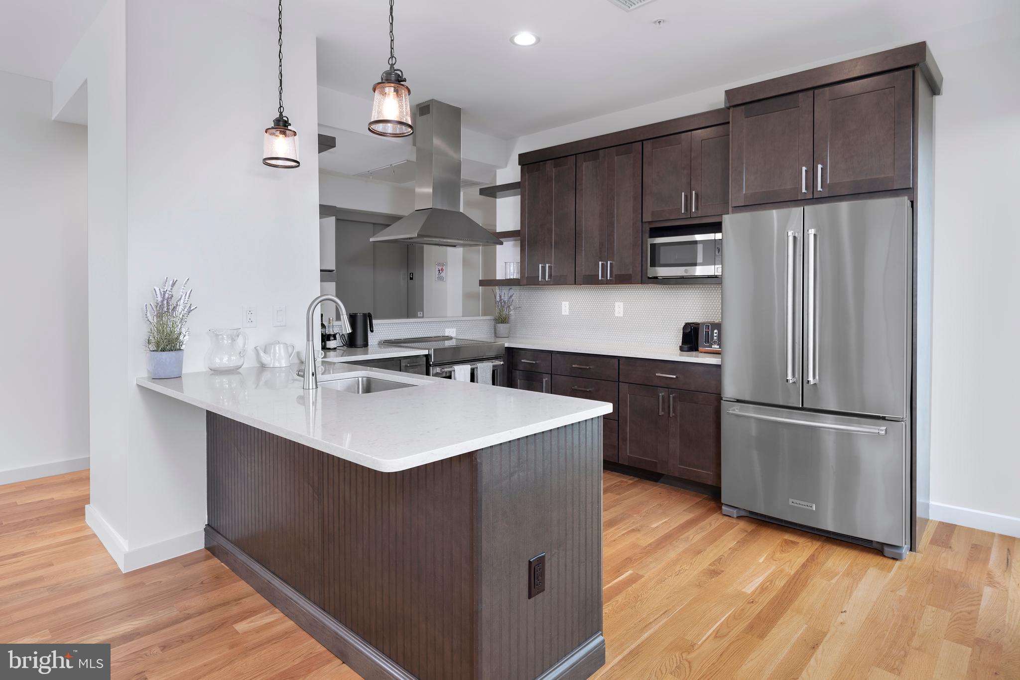 45 Spring Street, Unit PH6 Princeton, NJ 08542 - Photo 6 of 21 a kitchen with kitchen island a sink stainless steel appliances and cabinets