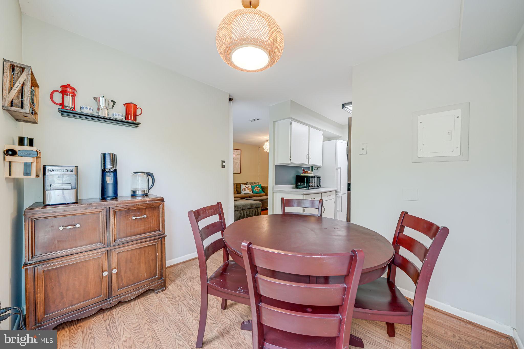11220 Chestnut Grove Square, Unit 222 Reston, VA 20190 - Photo 13 of 35 a dining room with furniture and wooden floor