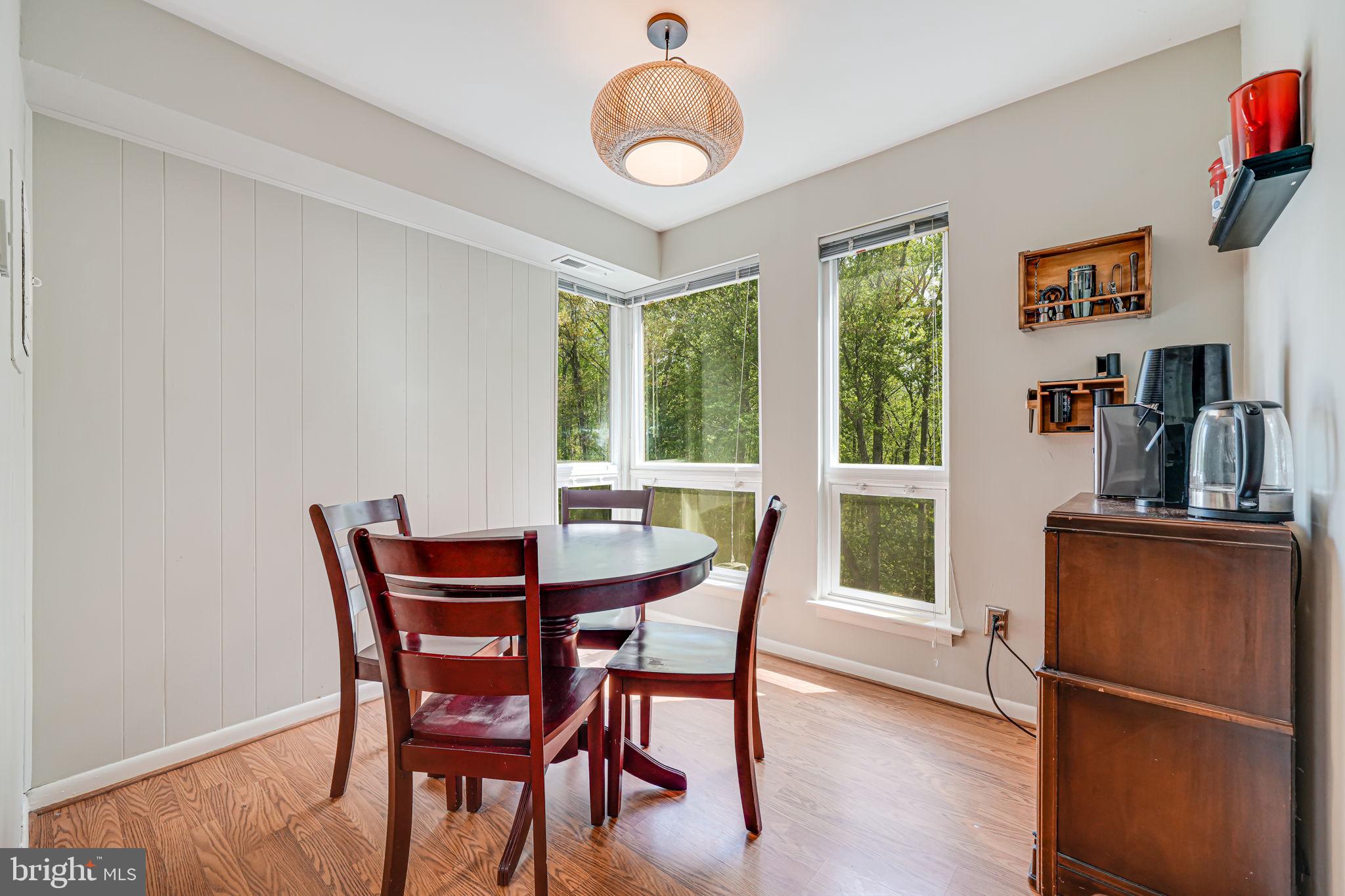 11220 Chestnut Grove Square, Unit 222 Reston, VA 20190 - Photo 14 of 35 a dining room with furniture and wooden floor