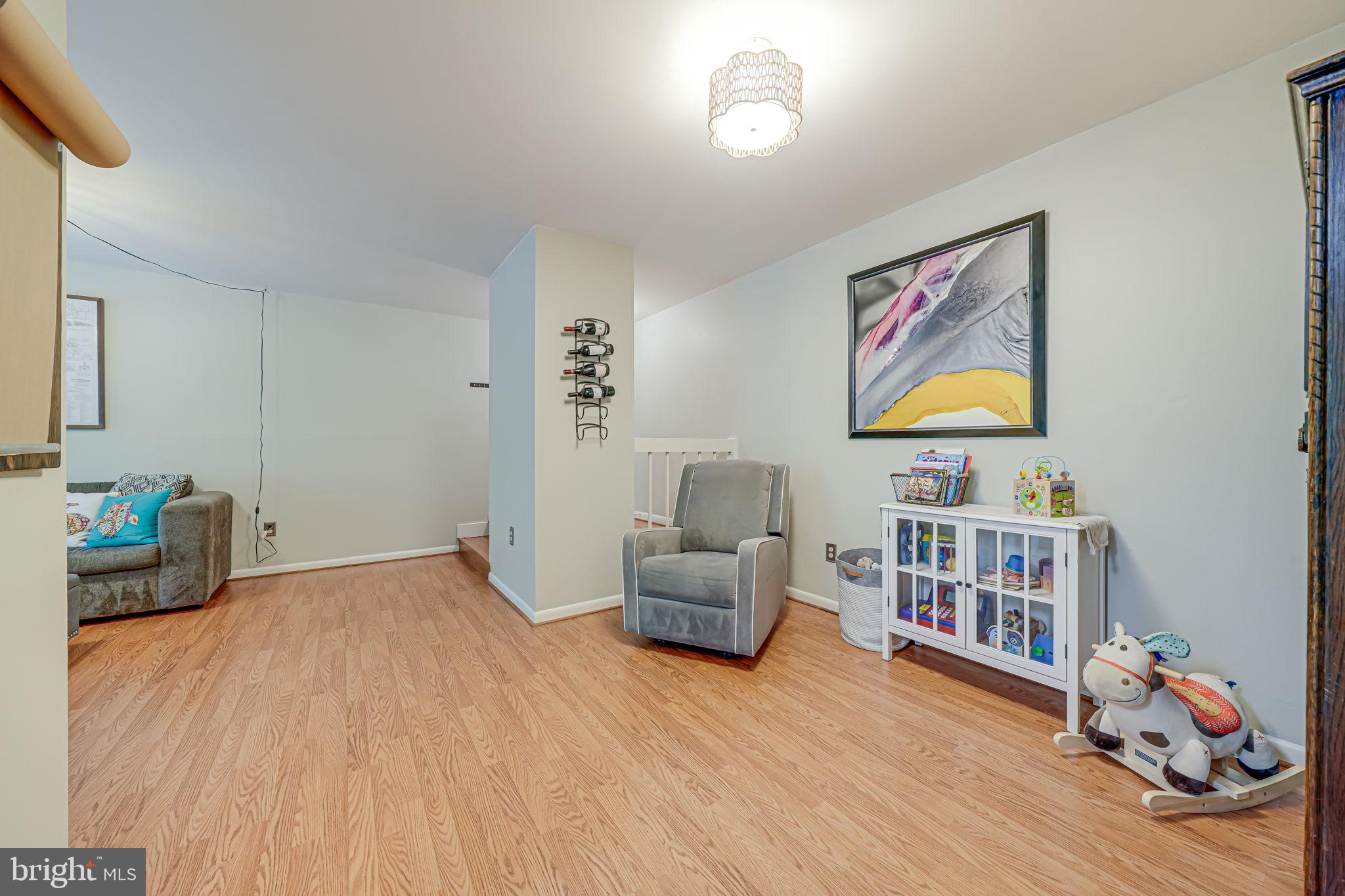 11220 Chestnut Grove Square, Unit 222 Reston, VA 20190 - Photo 15 of 35 a bedroom with furniture and a book shelf