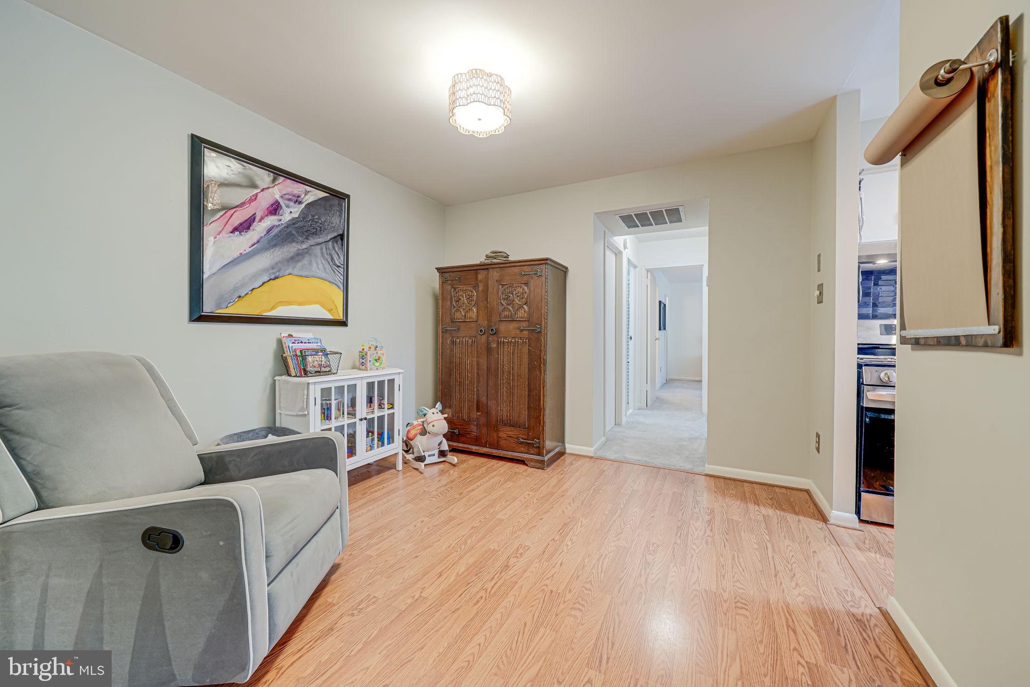 11220 Chestnut Grove Square, Unit 222 Reston, VA 20190 - Photo 16 of 35 a living room with furniture and a wooden floor