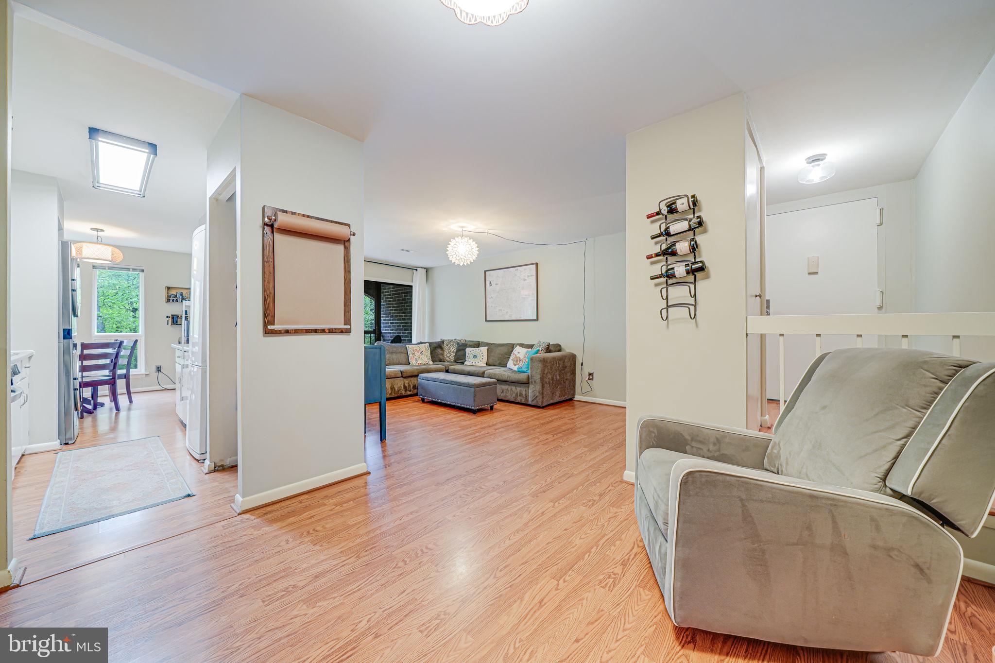 11220 Chestnut Grove Square, Unit 222 Reston, VA 20190 - Photo 17 of 35 a living room with furniture and a wooden floor