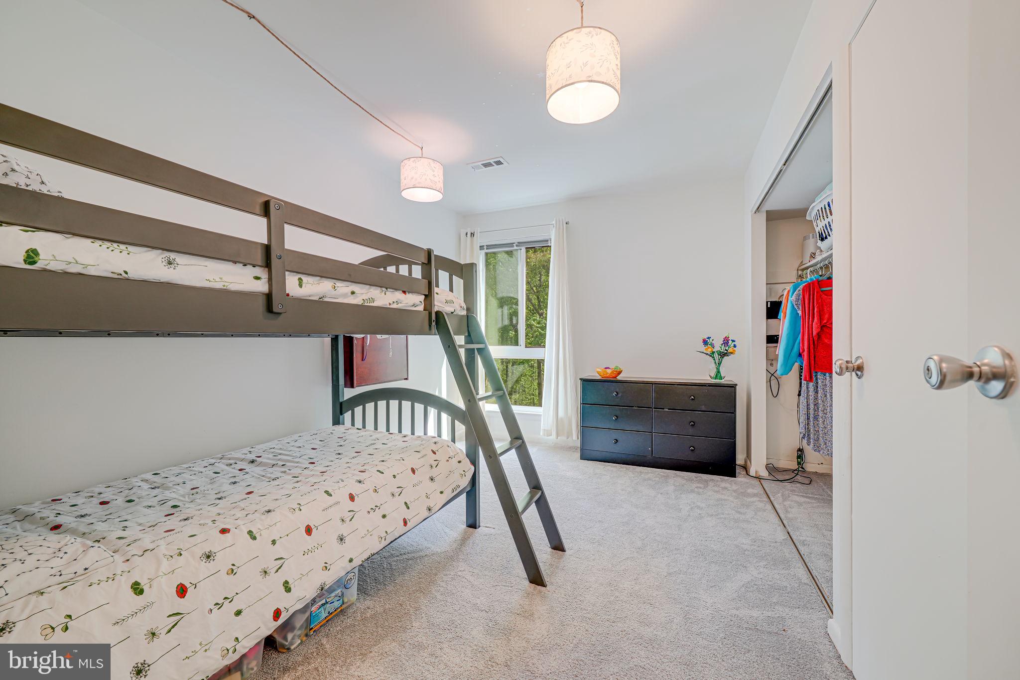 11220 Chestnut Grove Square, Unit 222 Reston, VA 20190 - Photo 19 of 35 a bedroom with furniture and a window