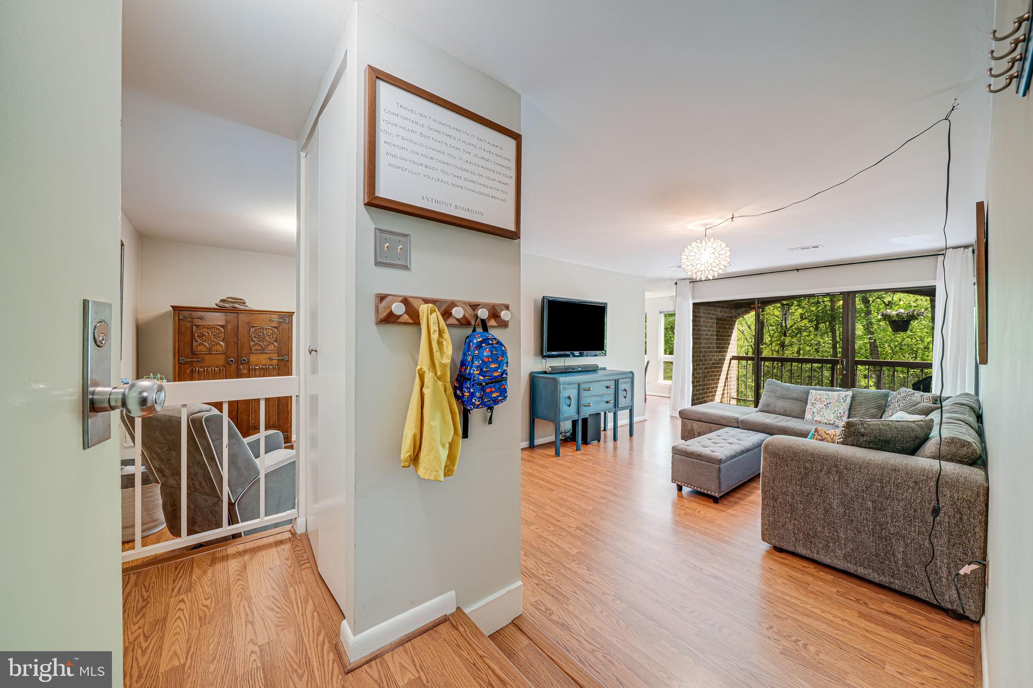 11220 Chestnut Grove Square, Unit 222 Reston, VA 20190 - Photo 2 of 35 a living room with furniture and a flat screen tv