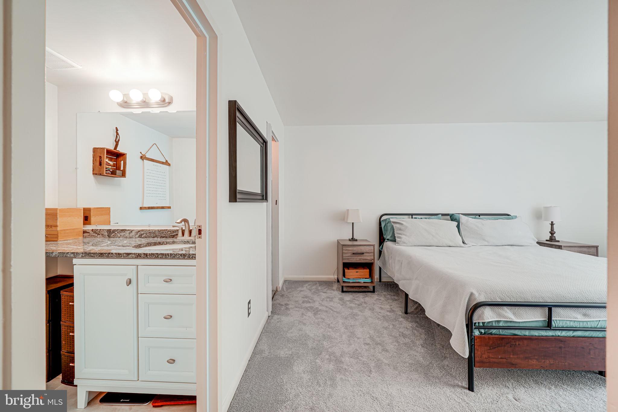 11220 Chestnut Grove Square, Unit 222 Reston, VA 20190 - Photo 27 of 35 a bed room with a bed and a lamp