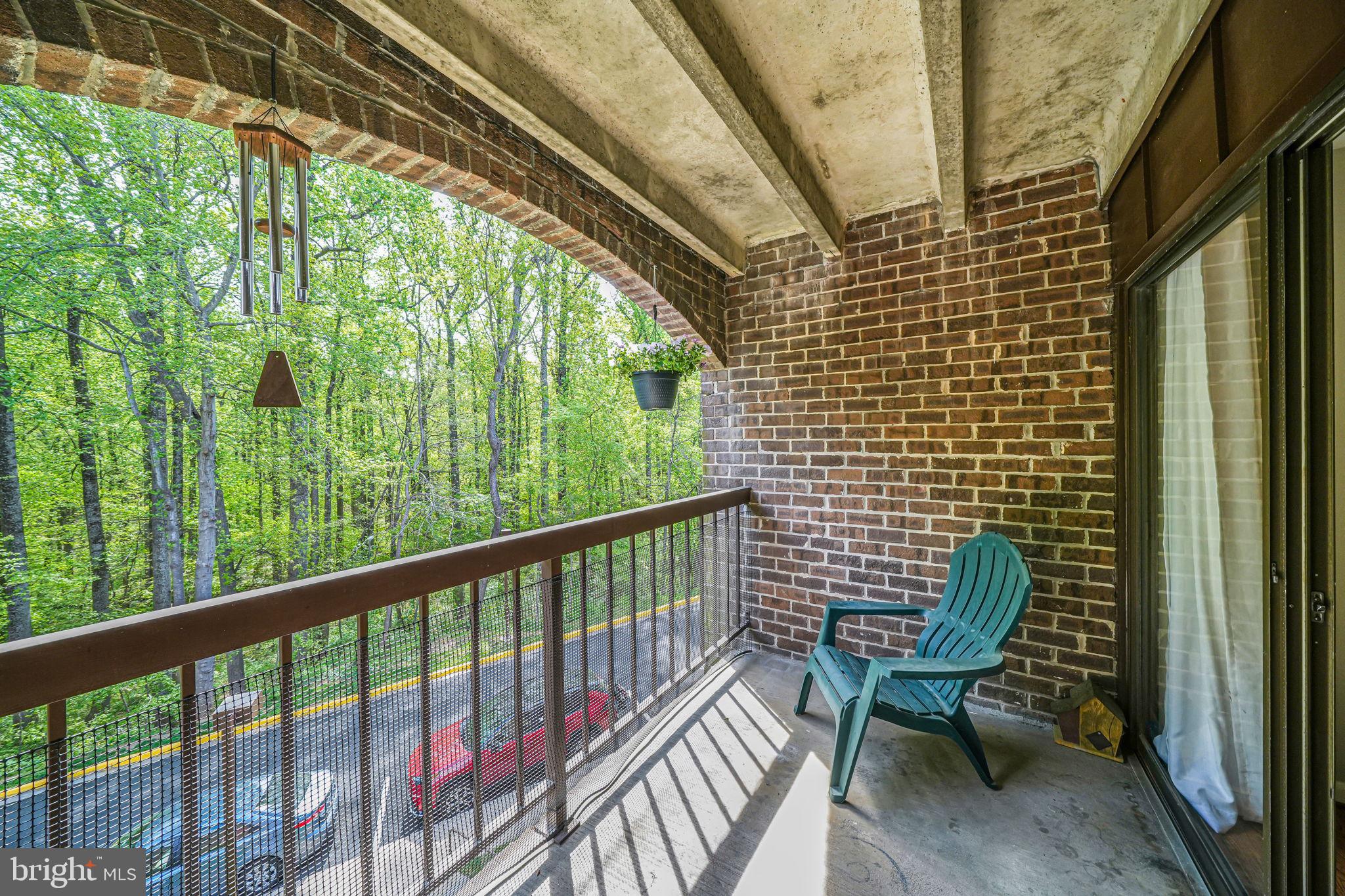 11220 Chestnut Grove Square, Unit 222 Reston, VA 20190 - Photo 30 of 35 a view of a chair and table in the balcony