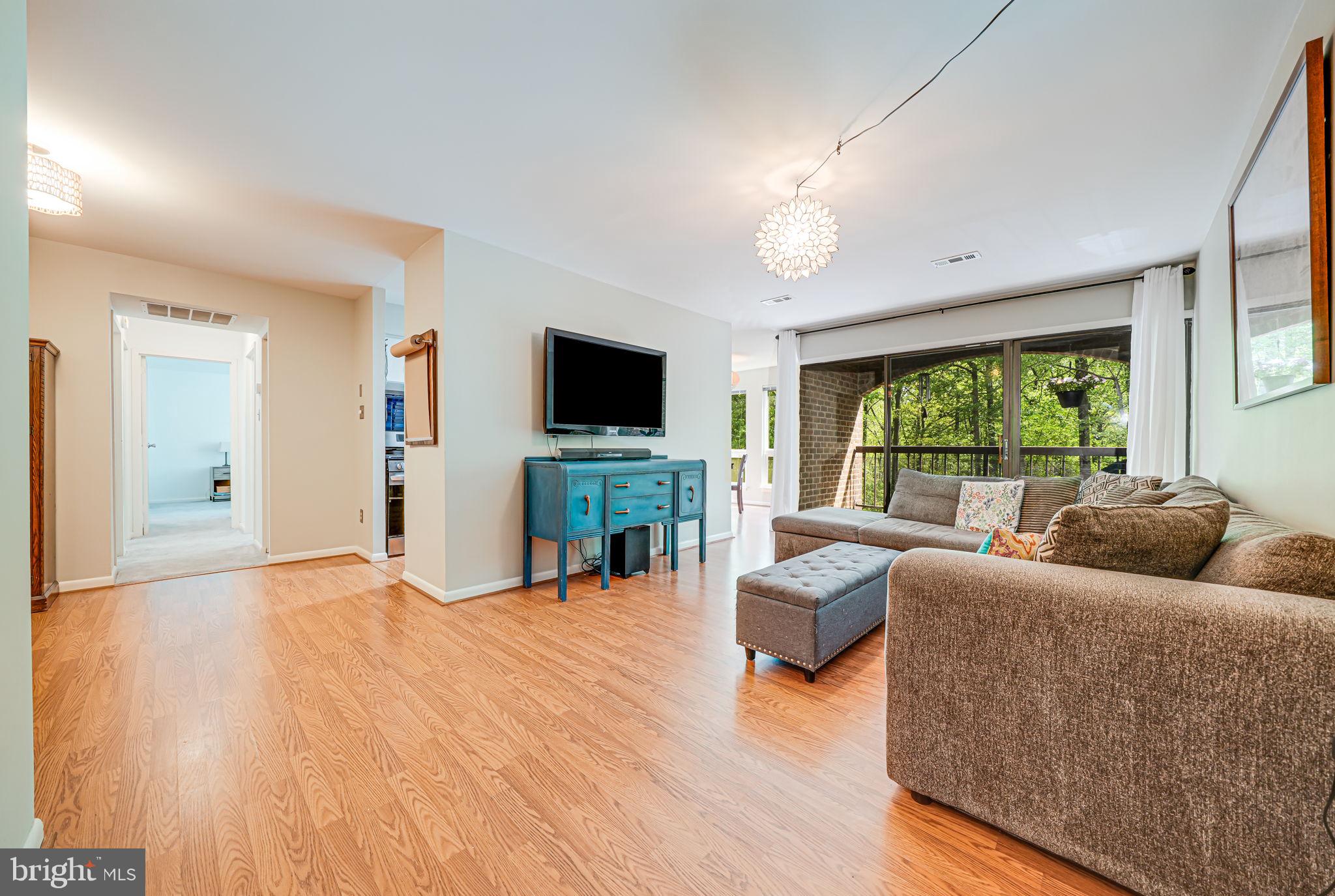 11220 Chestnut Grove Square, Unit 222 Reston, VA 20190 - Photo 3 of 35 a living room with furniture and a flat screen tv