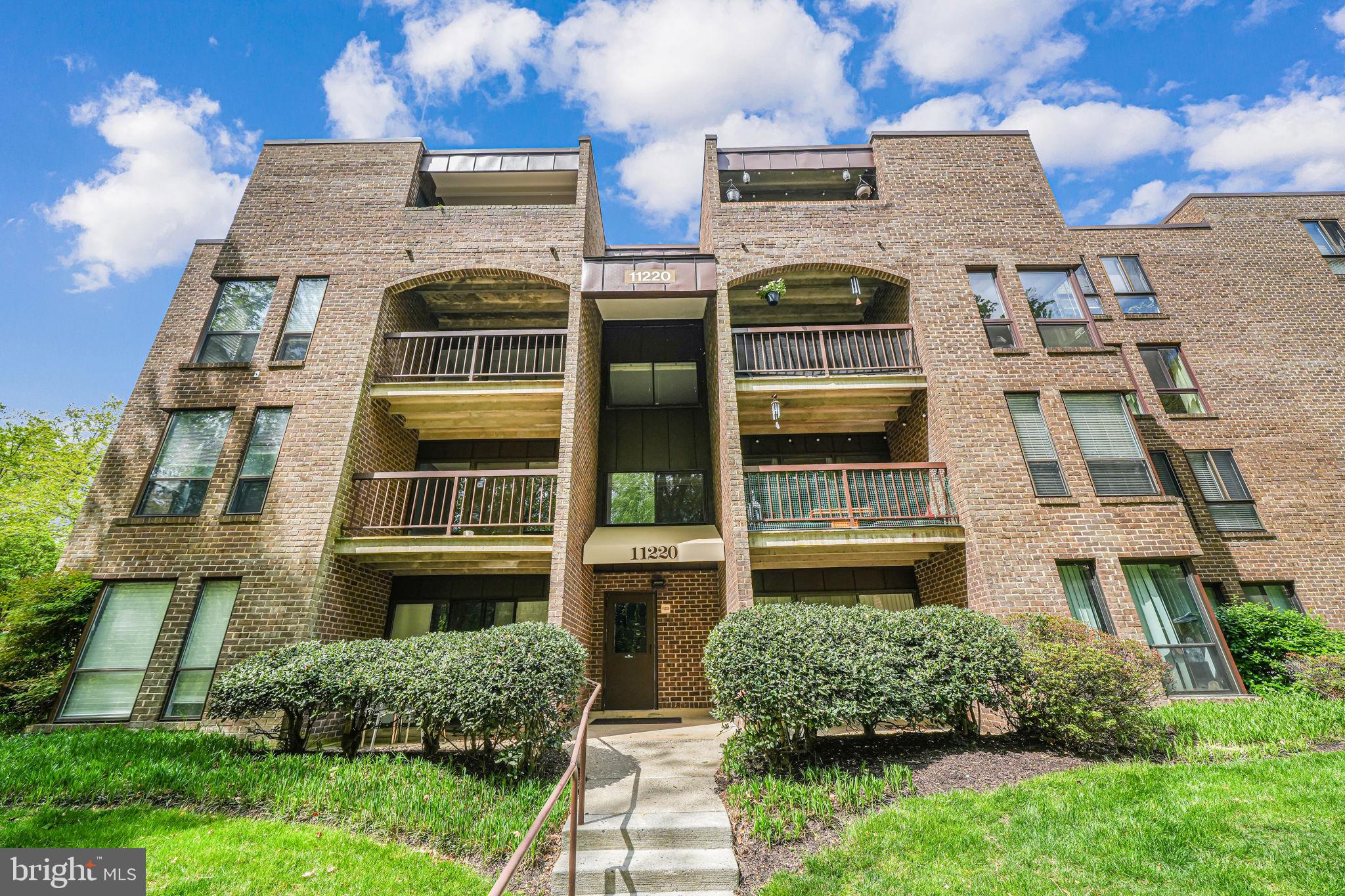 11220 Chestnut Grove Square, Unit 222 Reston, VA 20190 - Photo 33 of 35 a front view of a multi story building