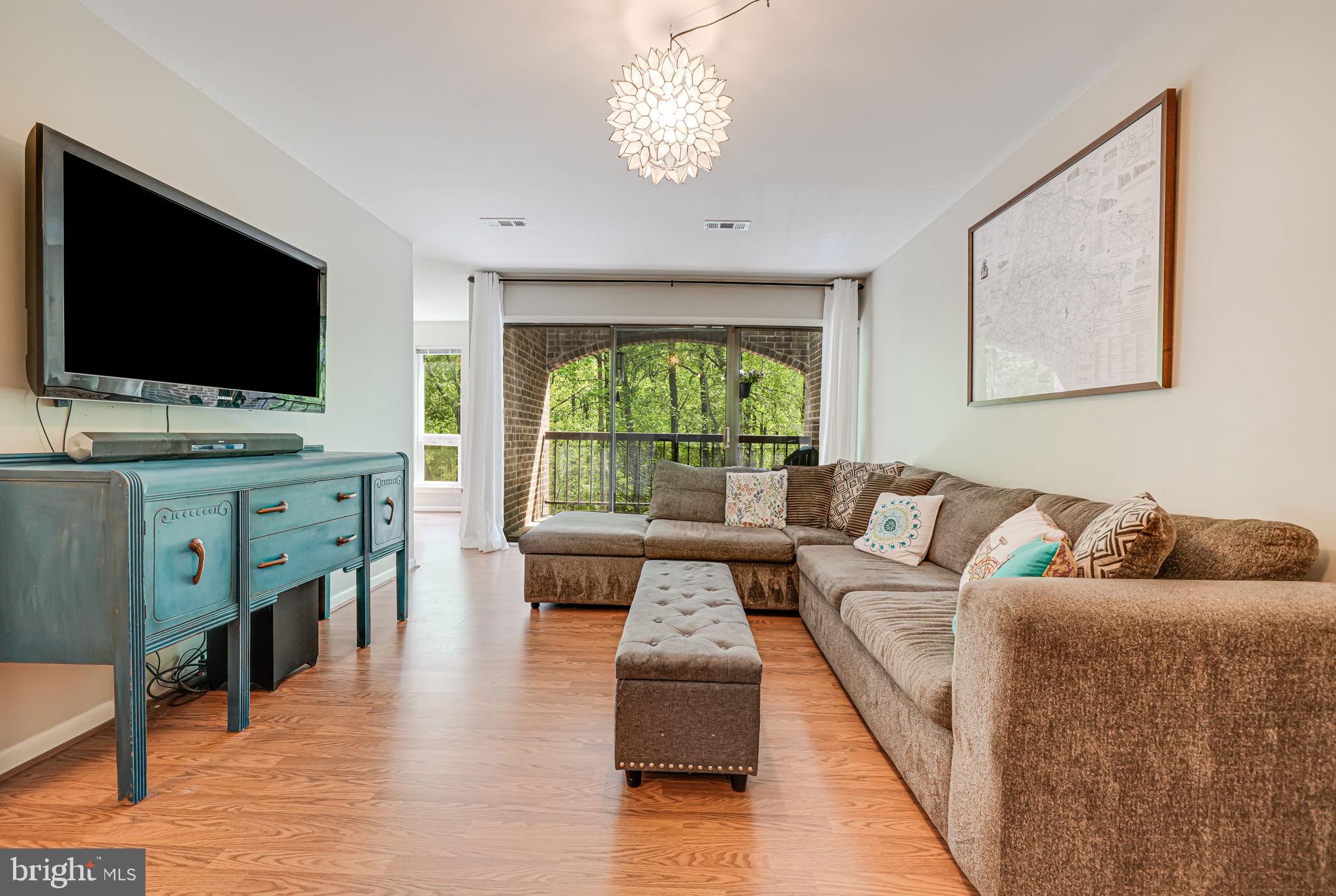 11220 Chestnut Grove Square, Unit 222 Reston, VA 20190 - Photo 4 of 35 a living room with furniture and a flat screen tv