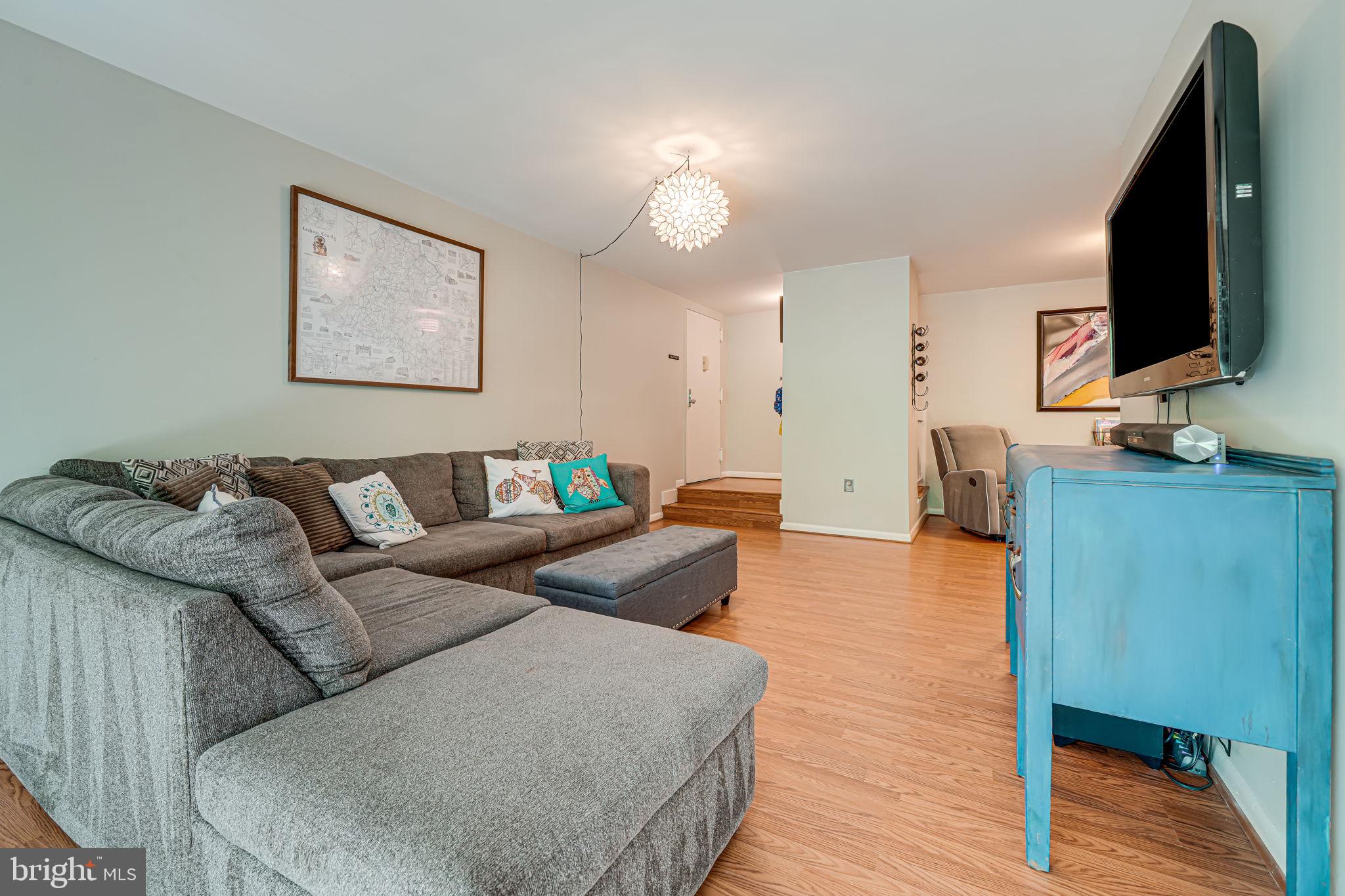 11220 Chestnut Grove Square, Unit 222 Reston, VA 20190 - Photo 6 of 35 a living room with furniture and a flat screen tv