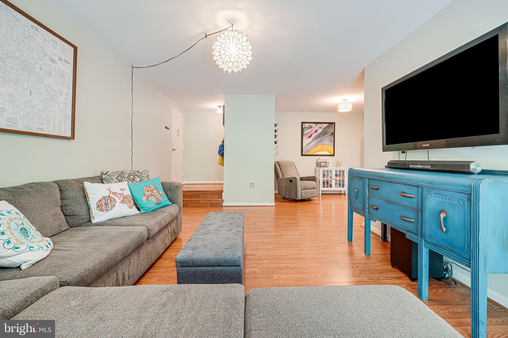 11220 Chestnut Grove Square, Unit 222 Reston, VA 20190 - Photo 7 of 35 a living room with furniture and a flat screen tv