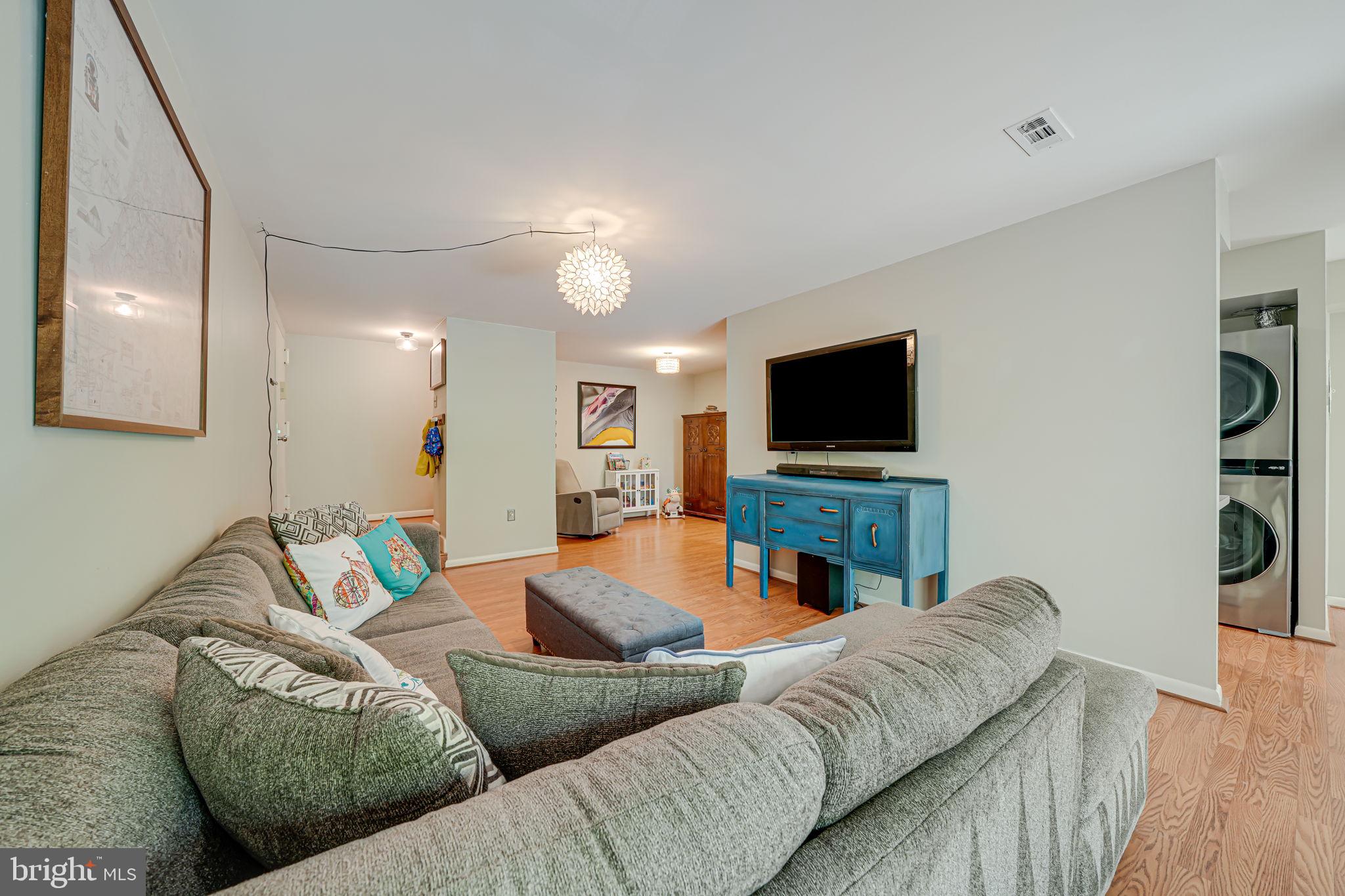 11220 Chestnut Grove Square, Unit 222 Reston, VA 20190 - Photo 8 of 35 a living room with furniture and a flat screen tv