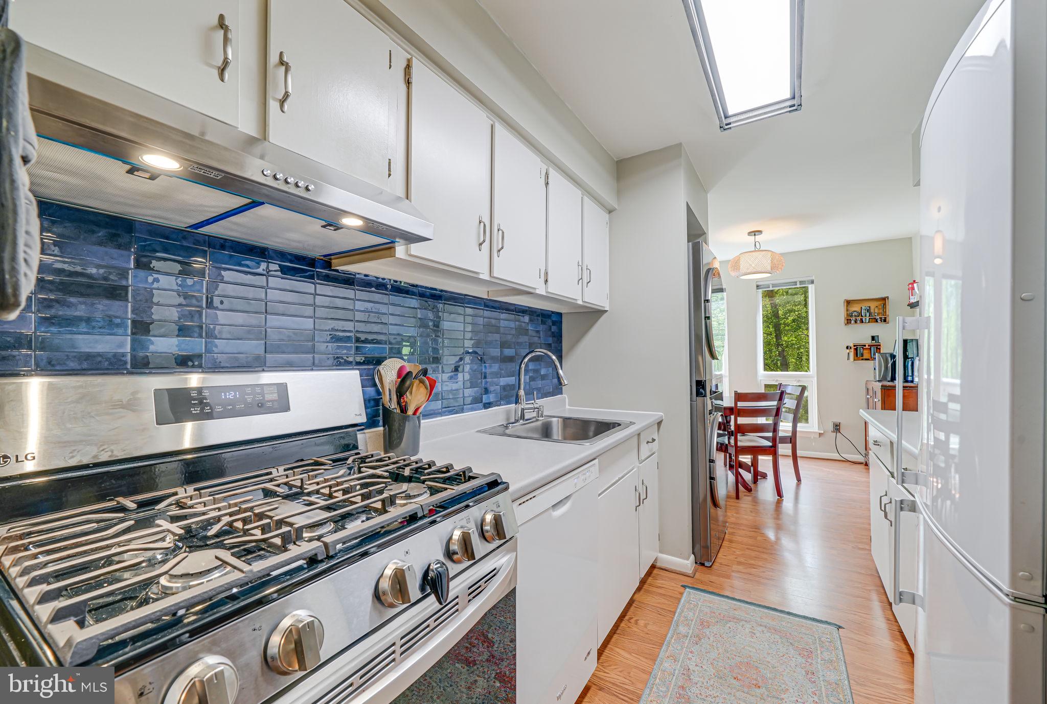 11220 Chestnut Grove Square, Unit 222 Reston, VA 20190 - Photo 10 of 35 a kitchen with stainless steel appliances granite countertop a stove and a sink