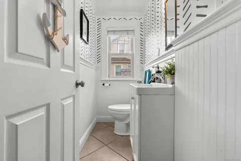a bathroom with a sink mirror and toilet