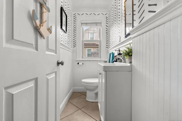 a bathroom with a sink mirror and toilet