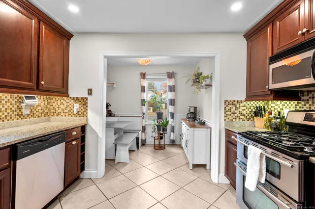 a kitchen with stainless steel appliances granite countertop a stove refrigerator and microwave