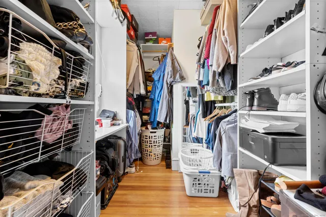 a bedroom with baby bed and a window