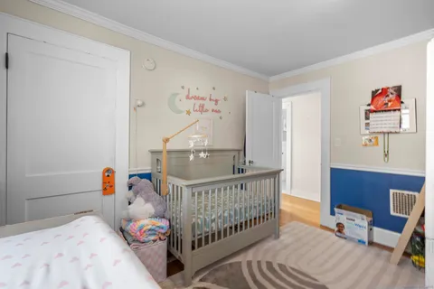 a bedroom with a bed and a painting on the wall