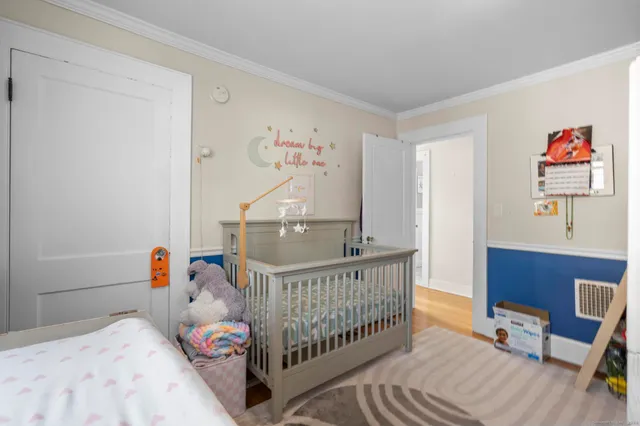 a bedroom with a bed and a painting on the wall